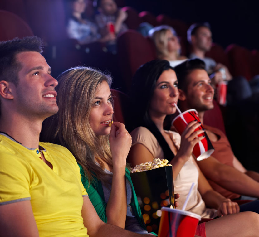 group of friends at a theater enjoying a movie